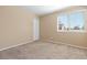 Bedroom with neutral carpet and paint and a window that provides natural light at 2640 Overlook Dr, Broomfield, CO 80020