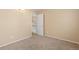 A neutral bedroom features neutral carpet, paint, a closet, and a transom window above the door at 2640 Overlook Dr, Broomfield, CO 80020