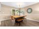 Well-lit dining room with a unique table, bench, modern light fixture, and large window at 2640 Overlook Dr, Broomfield, CO 80020
