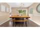 Bright dining room with a unique table, chairs, bench, and large windows for natural light at 2640 Overlook Dr, Broomfield, CO 80020