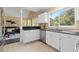 Modern kitchen featuring stainless steel appliances, white cabinets, and easy access to the living room at 2640 Overlook Dr, Broomfield, CO 80020
