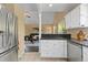 Bright kitchen with stainless steel appliances and an open layout to the living room at 2640 Overlook Dr, Broomfield, CO 80020