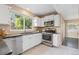 Bright kitchen featuring white cabinets, stainless steel appliances, and natural light at 2640 Overlook Dr, Broomfield, CO 80020