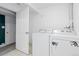Laundry room features a washing machine and a dryer near a white door at 2640 Overlook Dr, Broomfield, CO 80020