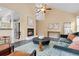 Bright living room featuring a fireplace, vaulted ceiling, and easy access to the kitchen at 2640 Overlook Dr, Broomfield, CO 80020