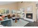 Cozy living room with a fireplace, large windows, and an open layout to the kitchen at 2640 Overlook Dr, Broomfield, CO 80020
