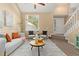 Cozy living room featuring a sofa, accent chairs, natural light, and tasteful decor at 2640 Overlook Dr, Broomfield, CO 80020