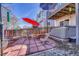 Relaxing back patio with an umbrella, seating, and a hot tub for outdoor enjoyment at 12868 Capital Creek St, Parker, CO 80134