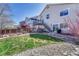 Scenic backyard with green lawn, garden area, a deck, and a hot tub at 12868 Capital Creek St, Parker, CO 80134