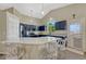 Stylish kitchen with navy cabinets, granite counters, bar seating, and stainless steel appliances at 12868 Capital Creek St, Parker, CO 80134