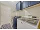Spacious laundry room with modern washer and dryer, storage cabinets, and utility sink at 12868 Capital Creek St, Parker, CO 80134