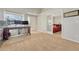 Bright office area with a large window, neutral carpet, and doorway to bedroom with red-accented bedding at 12868 Capital Creek St, Parker, CO 80134
