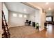 Open-concept living room featuring neutral walls, plush carpeting, and stylish wood flooring accents at 27089 E Cedar Ave, Aurora, CO 80018