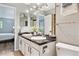Bathroom featuring a dual sink vanity with granite counters and modern lighting at 1060 S Parker Rd # 25, Denver, CO 80231