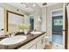 Bathroom featuring dual sinks, granite countertops, and a shower tub at 1060 S Parker Rd # 25, Denver, CO 80231