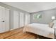 Serene bedroom with wood floors, a comfortable bed, large closet, and a bright window with outside view at 1060 S Parker Rd # 25, Denver, CO 80231