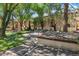 Outdoor community space with garden, mature shade trees, and plenty of seating at 1060 S Parker Rd # 25, Denver, CO 80231