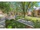 Beautifully landscaped courtyard with mature trees, tables, and seating areas at 1060 S Parker Rd # 25, Denver, CO 80231