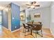 Cozy dining area with hardwood floors, a round table with chairs, and a ceiling fan at 1060 S Parker Rd # 25, Denver, CO 80231