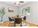 Charming dining area featuring hardwood floors, bright natural light, and a round table with chairs at 1060 S Parker Rd # 25, Denver, CO 80231