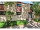 Charming condo exterior with private patio and well-maintained landscaping at 1060 S Parker Rd # 25, Denver, CO 80231