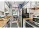 Well-lit kitchen with stainless steel appliances and granite countertops adjacent to the dining area at 1060 S Parker Rd # 25, Denver, CO 80231
