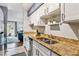Bright kitchen featuring granite countertops, white cabinetry, and stainless steel appliances at 1060 S Parker Rd # 25, Denver, CO 80231