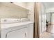 Laundry room featuring white washer and dryer units next to a hall leading to other rooms at 1060 S Parker Rd # 25, Denver, CO 80231
