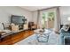 Bright living room features hardwood floors, modern decor, and a sliding glass door to the outdoor space at 1060 S Parker Rd # 25, Denver, CO 80231