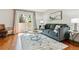 Bright living room features hardwood floors, a comfortable sofa, a sliding glass door, and stylish decor at 1060 S Parker Rd # 25, Denver, CO 80231