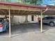 Assigned carport parking spaces under wooden beam structure at 1060 S Parker Rd # 25, Denver, CO 80231