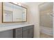 Well-lit bathroom with gray vanity, white countertop, and a combined bath and shower at 10185 W 25Th Ave # 33, Lakewood, CO 80215