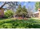 The condo courtyard features a seating area and mature trees at 10185 W 25Th Ave # 33, Lakewood, CO 80215