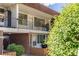 A condo building featuring balconies, red brick accents, and a well-manicured lawn at 10185 W 25Th Ave # 33, Lakewood, CO 80215