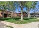 Exterior shot of the condo building with a beautifully maintained courtyard and mature trees at 10185 W 25Th Ave # 33, Lakewood, CO 80215