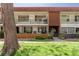 Charming condo building with brown accents, black metal railings, and a well-maintained lawn at 10185 W 25Th Ave # 33, Lakewood, CO 80215