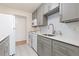Bright kitchen features gray cabinets, stainless steel sink, white subway tile backsplash and modern appliances at 10185 W 25Th Ave # 33, Lakewood, CO 80215