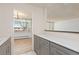 Modern kitchen featuring gray cabinets, light countertops, and an open view to the living area at 10185 W 25Th Ave # 33, Lakewood, CO 80215
