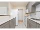 Bright kitchen features gray cabinets and white appliances, providing a modern and functional space at 10185 W 25Th Ave # 33, Lakewood, CO 80215
