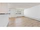 Bright living space with sleek flooring, a kitchen view, and big windows showcasing the outdoors at 10185 W 25Th Ave # 33, Lakewood, CO 80215