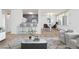 Open-concept living area with bar seating, an adjacent dining area, and lots of natural light at 10185 W 25Th Ave # 33, Lakewood, CO 80215
