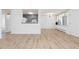 Bright and airy living space features updated flooring, a glimpse of the kitchen, and large windows at 10185 W 25Th Ave # 33, Lakewood, CO 80215