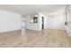 Open living space featuring sleek floors, a partial view of the kitchen, and abundant natural light at 10185 W 25Th Ave # 33, Lakewood, CO 80215