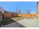 A fenced backyard with a brick structure, grassy lawn, and a concrete patio at 1467 Clermont St, Denver, CO 80220