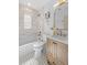 Bright bathroom featuring tile flooring, tub, and vanity with framed mirror, along with great natural lighting at 1467 Clermont St, Denver, CO 80220