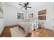 Bright bedroom featuring wood floors, a ceiling fan, and natural light at 1467 Clermont St, Denver, CO 80220