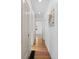 Hallway with hardwood floors, recessed lighting, and white walls, with a glimpse of an adjacent room at 1467 Clermont St, Denver, CO 80220