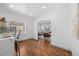 Open-concept kitchen leads to dining area, featuring an island with counter seating and hardwood floors at 1467 Clermont St, Denver, CO 80220