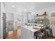 Modern kitchen with stainless appliances, pendant lighting, and an island with counter seating for casual dining at 1467 Clermont St, Denver, CO 80220