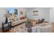 Bright living room featuring hardwood floors, a decorative rug, comfortable seating, and arched doorways at 1467 Clermont St, Denver, CO 80220